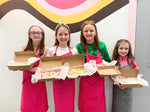 happy group of 4 girls with boxes of products 